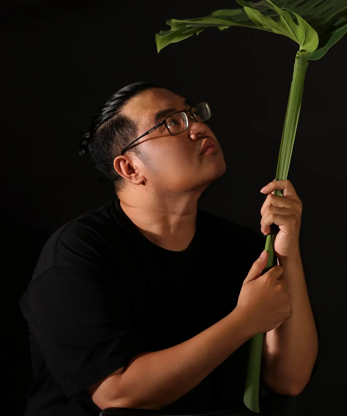Profile portrait of a man in a white shirt against a light background