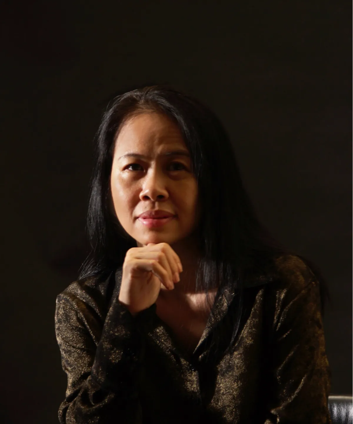 Profile portrait of a man in a white shirt against a light background